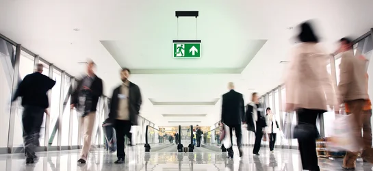 Interior view of a corridor in the airport with an emergency light 